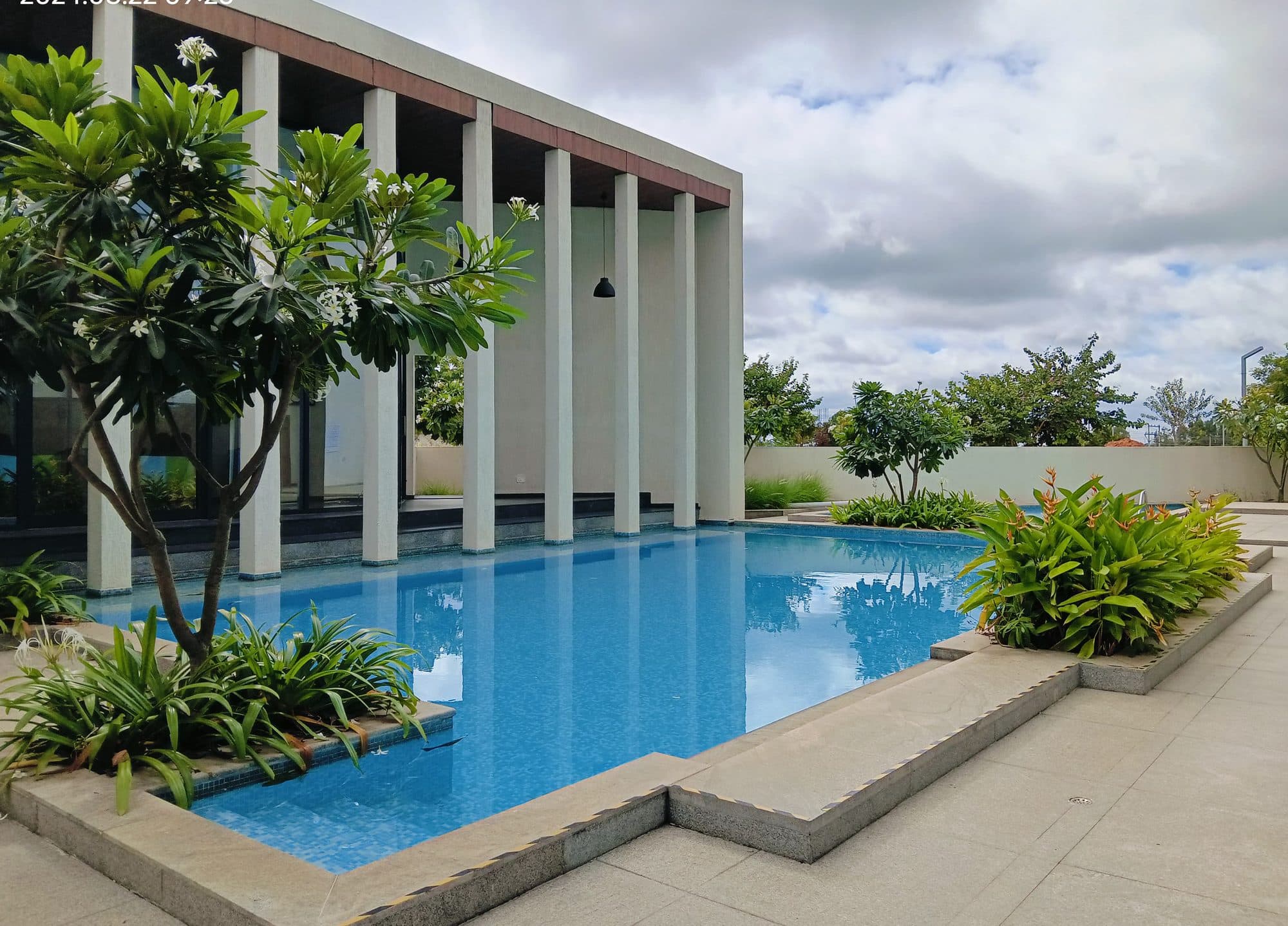 The pool and colonnade at Godrej Reserve